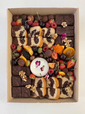 Tea Time Platter with marbled chocolate cake, homemade canelés, fudgy chocolate brownie, nuts, fresh fruits with vanilla yogurt dip and edible flowers